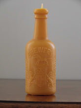 Load image into Gallery viewer, beeswax candle in the shape of an antique Alnwick brewery bottle