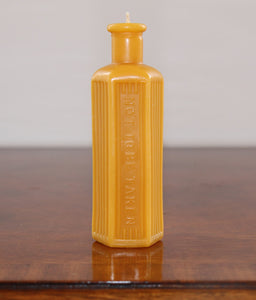 beeswax candle in the shape of an old poison bottle