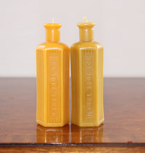 Load image into Gallery viewer, two beeswax candles in the shape of an old poison bottle
